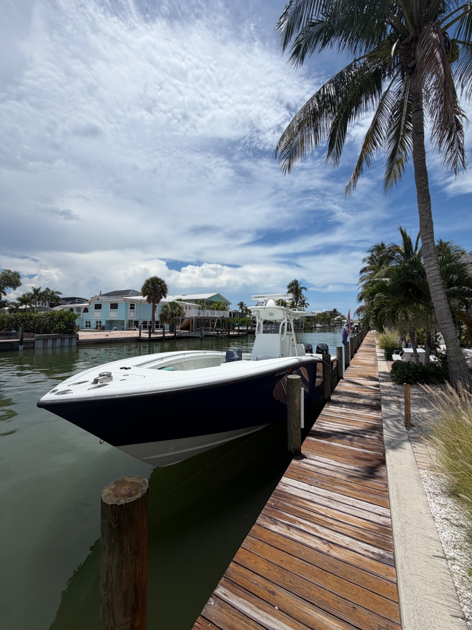 Black center console boat docked at Matanzas Marina, Fort Myers Beach