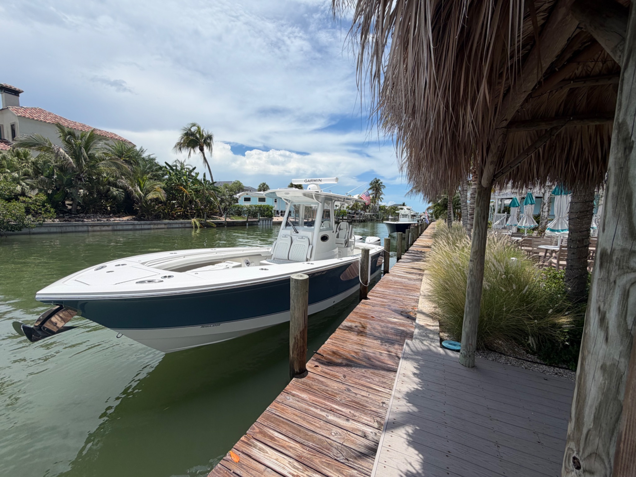 Center console boat at Matanzas Marina dock with restaurant outdoor seating visible