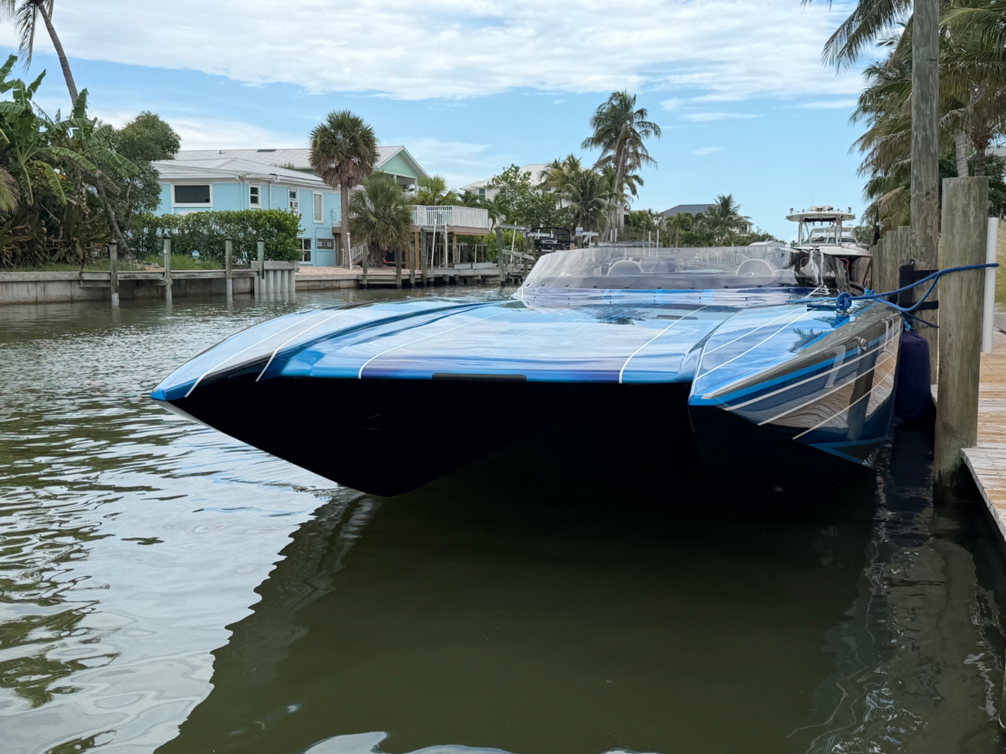 Sleek blue performance boat docked at Matanzas Marina